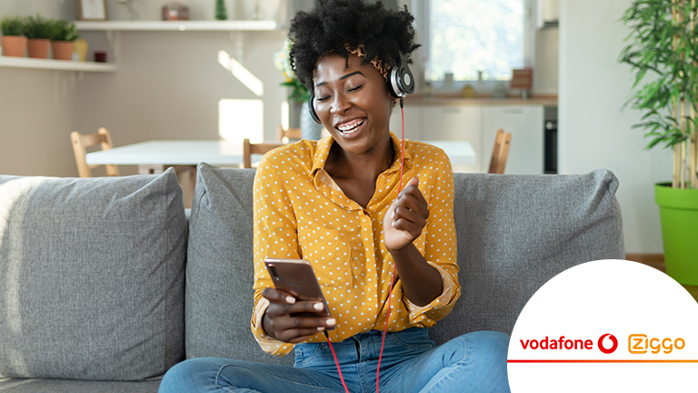 Happy woman is listening to music