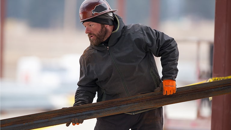 Man verplaatst een houten plank